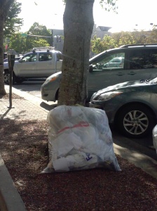 A trash bag on the sidewalk of downtown Athens more than 2 hours before scheduled pickup.